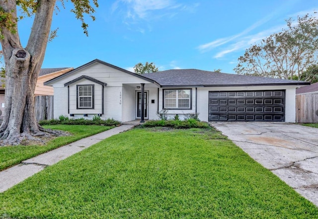 ranch-style house with fence, a front lawn, driveway, and brick siding