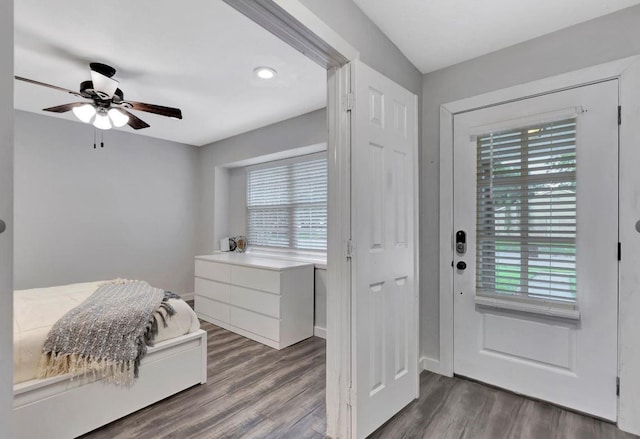 interior space featuring a ceiling fan and dark wood-type flooring