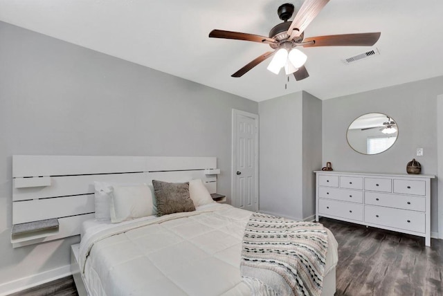bedroom featuring baseboards, a ceiling fan, visible vents, and dark wood-type flooring