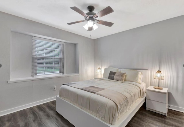 bedroom with ceiling fan, baseboards, and wood finished floors