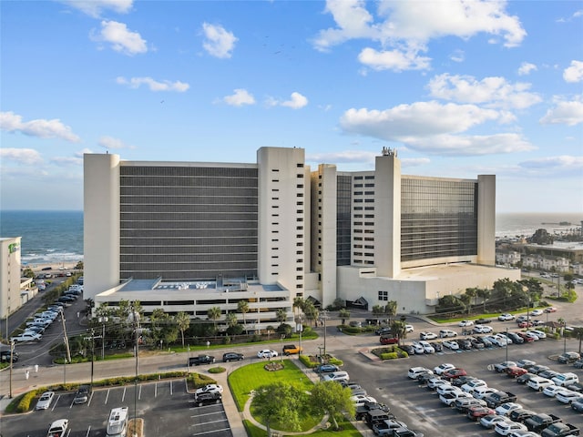 view of property featuring uncovered parking and a water view