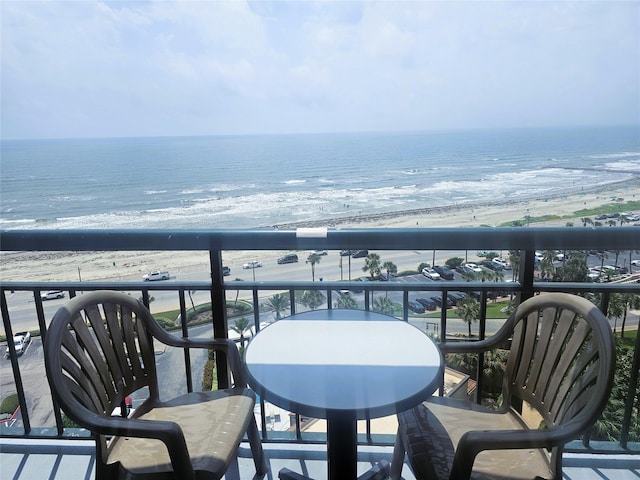 balcony featuring a water view and a view of the beach