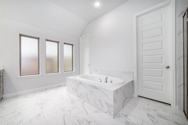 10419 Rigel Ridge Way, Richmond, TX 77406 - full bath with vanity, marble look tile flooring, a bath, vaulted ceiling, and baseboards