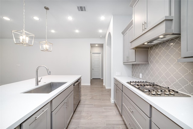 10419 Rigel Ridge Way, Richmond, TX 77406 - kitchen with a sink, gray cabinets, appliances with stainless steel finishes, range hood, and recessed lighting