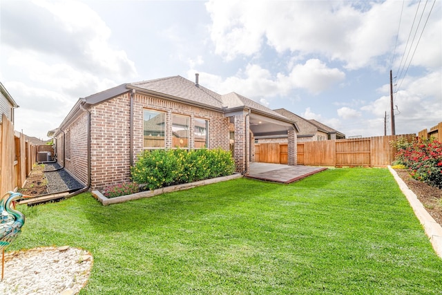 10419 Rigel Ridge Way, Richmond, TX 77406 - rear view of property featuring brick siding, roof with shingles, cooling unit, and a patio area