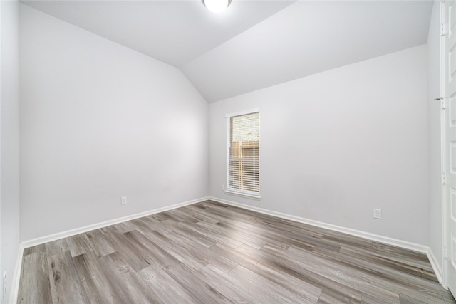 10419 Rigel Ridge Way, Richmond, TX 77406 - spare room with wood finished floors, vaulted ceiling, and baseboards