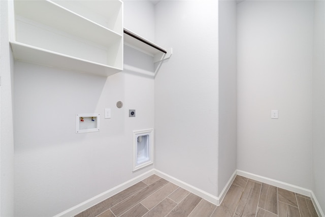 10419 Rigel Ridge Way, Richmond, TX 77406 - laundry room with hookup for an electric dryer, wood tiled floors, hookup for a washing machine, and baseboards
