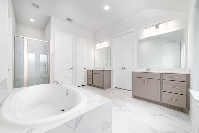 10419 Rigel Ridge Way, Richmond, TX 77406 - bathroom featuring two vanities, a bath, a marble finish shower, marble finish floors, and recessed lighting