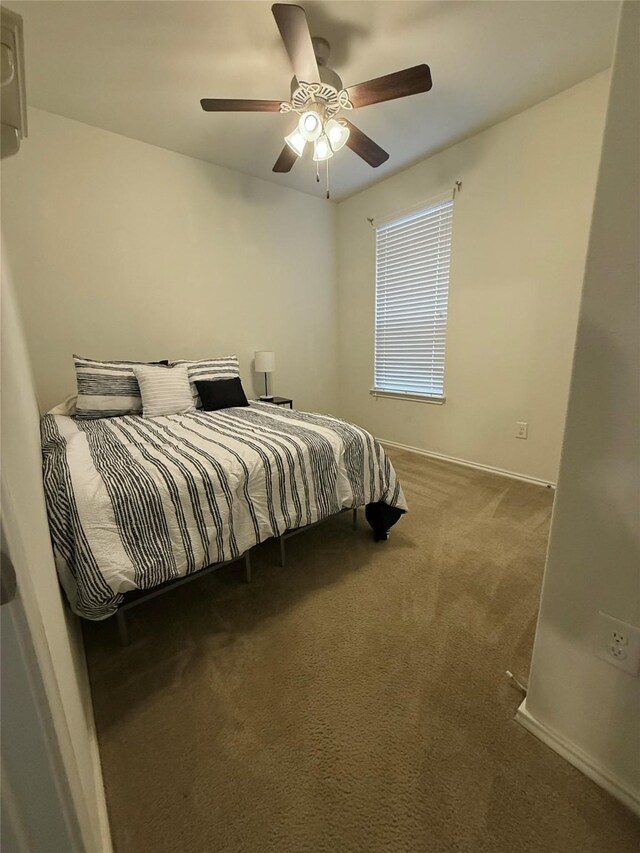 bedroom with carpet flooring, baseboards, and a ceiling fan