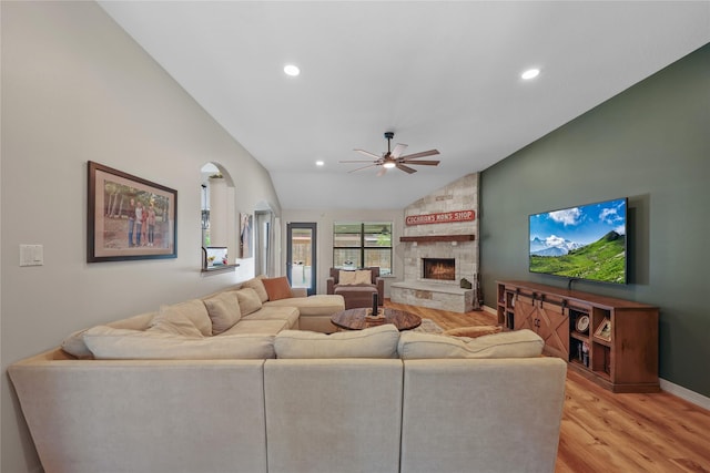 living room with a fireplace, light wood-style floors, a ceiling fan, recessed lighting, and vaulted ceiling
