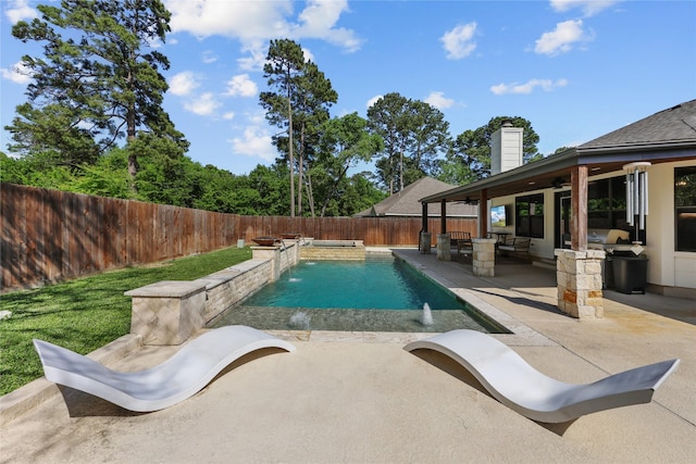 view of pool with ceiling fan, a patio area, a fenced in pool, a fenced backyard, and an outdoor kitchen