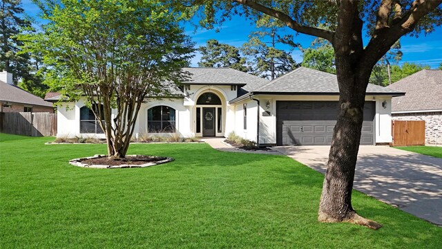 12010 Rainforest Ln, Montgomery, TX 77356 - view of front of home with a shingled roof, a garage, driveway, and stucco siding