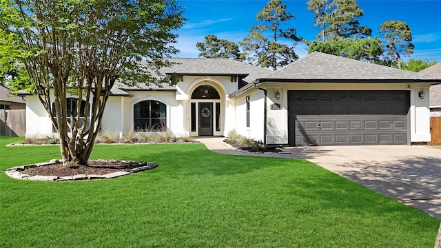 ranch-style home with a garage, stucco siding, driveway, and a front yard
