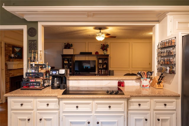 13710 Casaba Ct, Cypress, TX 77429 - kitchen featuring white cabinets, black electric cooktop, a ceiling fan, and light countertops