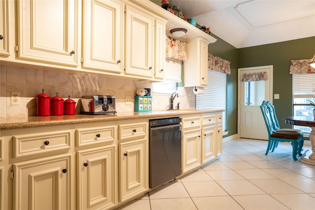 13710 Casaba Ct, Cypress, TX 77429 - kitchen with light tile patterned floors, a sink, black dishwasher, and cream cabinets