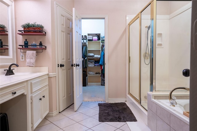 13710 Casaba Ct, Cypress, TX 77429 - bathroom featuring a shower stall, tile patterned floors, a spacious closet, vanity, and a relaxing tiled tub
