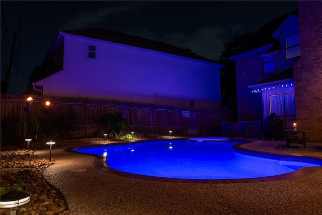 13710 Casaba Ct, Cypress, TX 77429 - pool at night with a fenced in pool, a fenced backyard, and an in ground hot tub