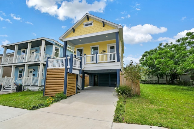 view of front of house with driveway, a porch, a front yard, and a carport