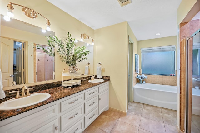full bathroom with visible vents, a sink, tile patterned floors, and a stall shower
