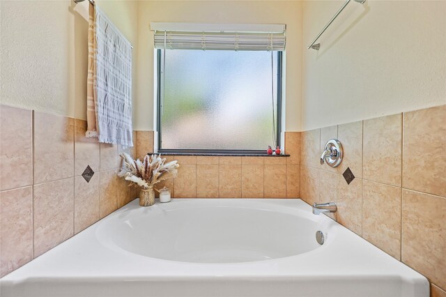 3226 Glen Forest Rd, Montgomery, TX 77356 - bathroom with a garden tub, tile walls, and wainscoting