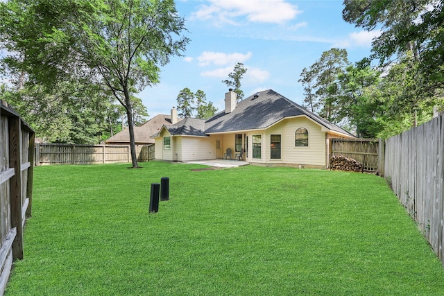 back of house featuring a lawn, a patio, and a fenced backyard