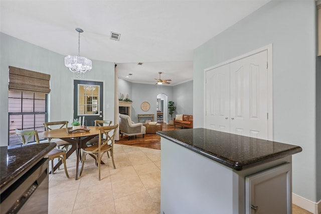 3226 Glen Forest Rd, Montgomery, TX 77356 - kitchen with a center island, decorative light fixtures, dark stone counters, arched walkways, and a ceiling fan