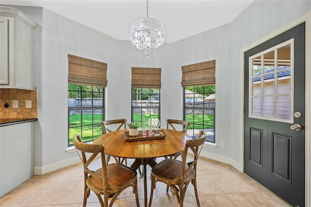 3226 Glen Forest Rd, Montgomery, TX 77356 - dining space featuring light tile patterned flooring, a chandelier, and baseboards