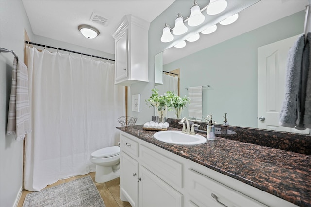 bathroom with tile patterned flooring, vanity, toilet, a shower with curtain, and visible vents