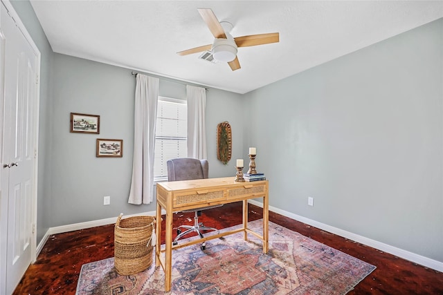 office space featuring a ceiling fan and baseboards
