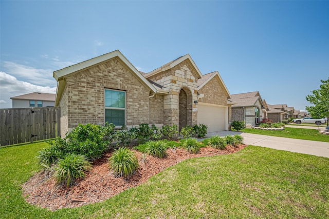 view of front of property featuring a front lawn, driveway, fence, a garage, and brick siding