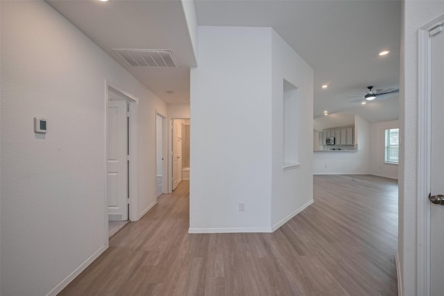 corridor with baseboards, wood finished floors, visible vents, and recessed lighting