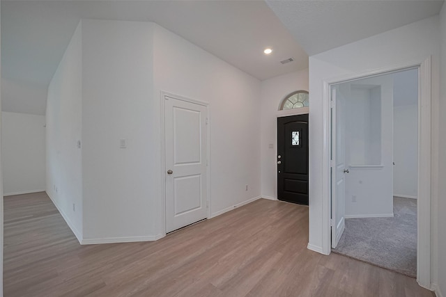 foyer with recessed lighting, light wood-type flooring, visible vents, and baseboards