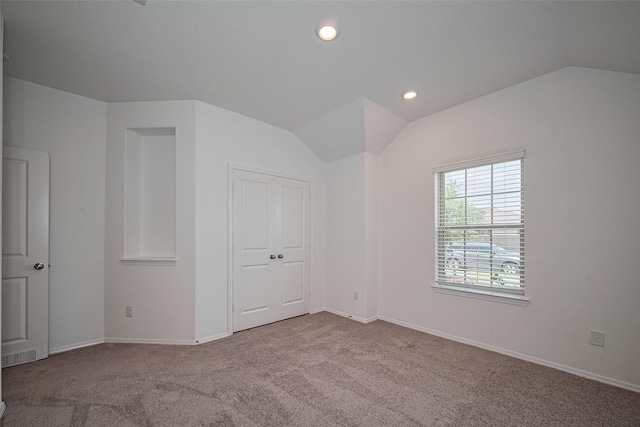 unfurnished bedroom with baseboards, lofted ceiling, carpet floors, and recessed lighting