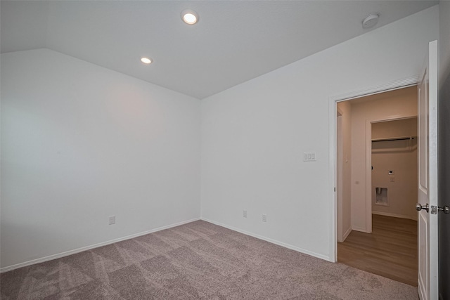 carpeted spare room with recessed lighting, lofted ceiling, and baseboards