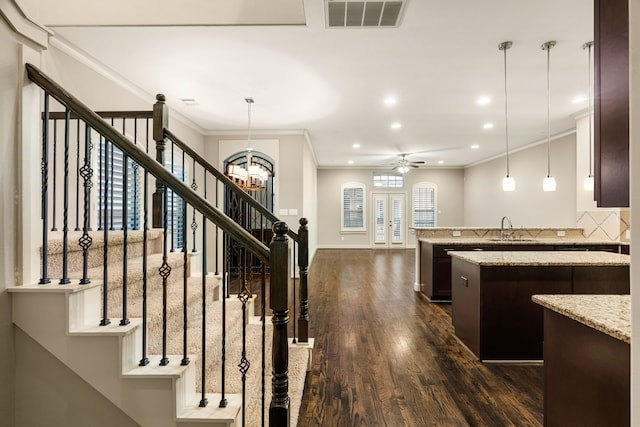 4205 Dickson St, Houston, TX 77007 - interior space featuring wood finished floors, visible vents, crown molding, and ceiling fan with notable chandelier