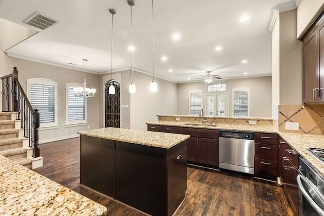 4205 Dickson St, Houston, TX 77007 - kitchen with dark brown cabinets, a sink, appliances with stainless steel finishes, dark wood-style flooring, and visible vents