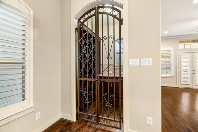 4205 Dickson St, Houston, TX 77007 - wine room featuring arched walkways, baseboards, dark wood-style flooring, and french doors