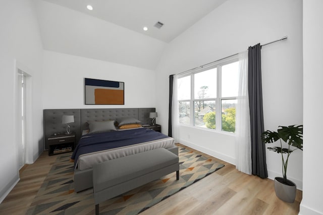 bedroom featuring light wood finished floors, baseboards, visible vents, recessed lighting, and high vaulted ceiling