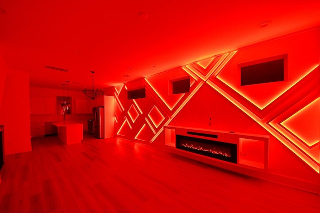 additional living space featuring wood finished floors and a fireplace