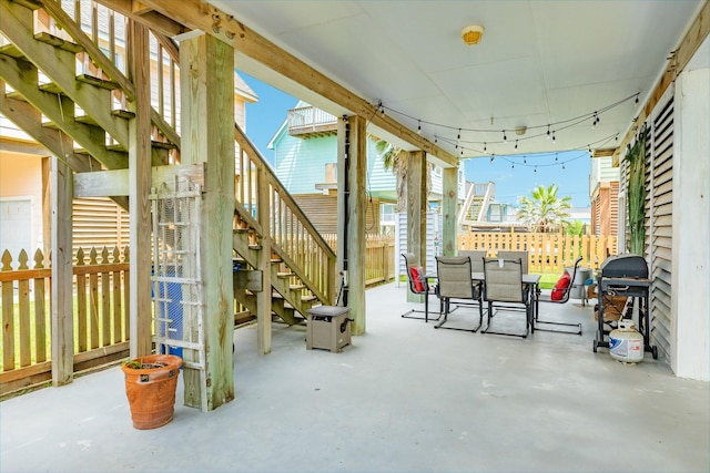 view of patio / terrace featuring stairs, grilling area, fence private yard, and outdoor dining space