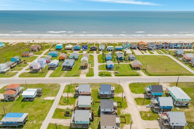 bird's eye view featuring a water view and a beach view