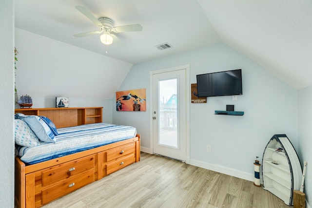 bedroom featuring visible vents, baseboards, lofted ceiling, and light wood finished floors