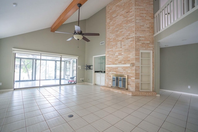 unfurnished living room featuring tile patterned floors, baseboards, high vaulted ceiling, and ceiling fan