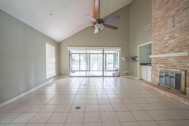 unfurnished living room featuring visible vents, a ceiling fan, light tile patterned flooring, baseboards, and high vaulted ceiling