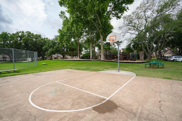 view of sport court featuring fence, a yard, and community basketball court