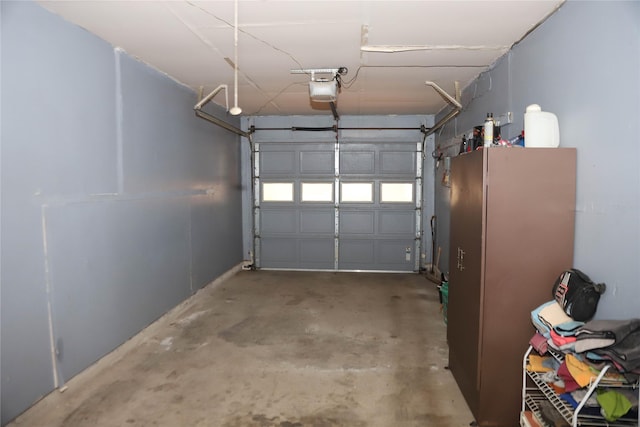 3104 Bonham Dr, Bryan, TX 77803 - garage with freestanding refrigerator and a garage door opener