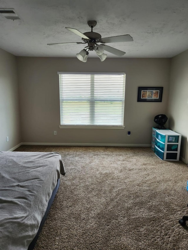 carpeted bedroom featuring baseboards, multiple windows, and visible vents