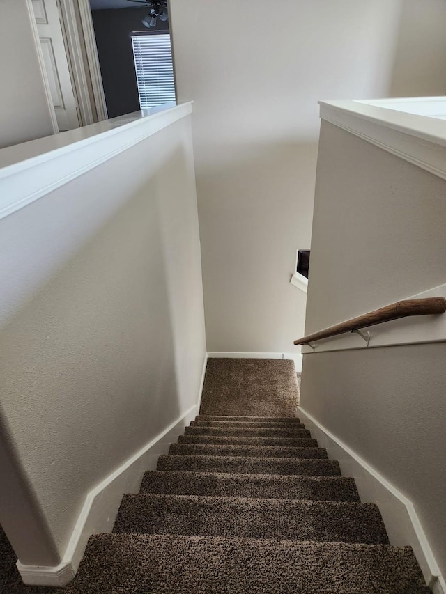 stairway with carpet floors and baseboards