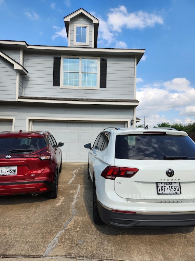 exterior space featuring an attached garage and concrete driveway