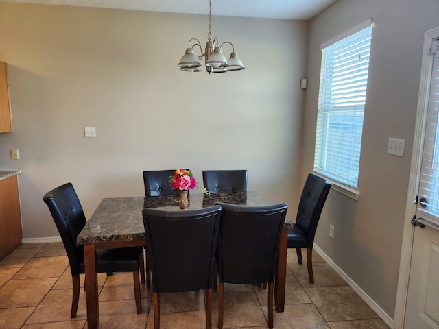15903 Winston Point Ln, Houston, TX 77084 - dining room featuring a chandelier, light tile patterned floors, and baseboards